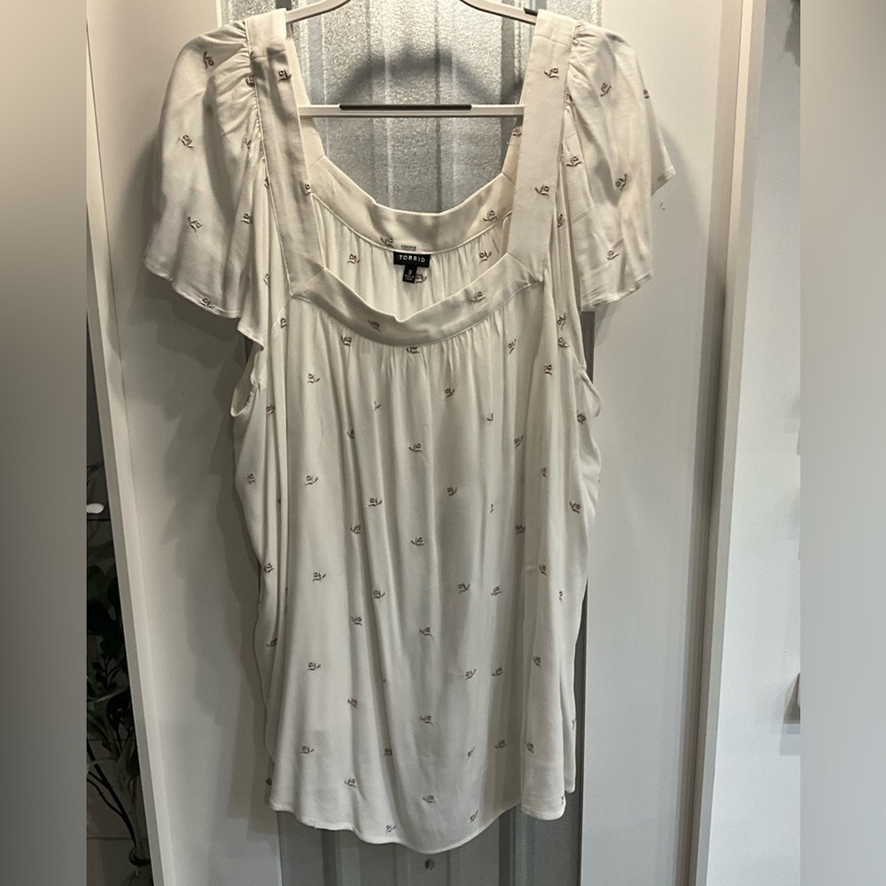 Torrid floral design white shirt.